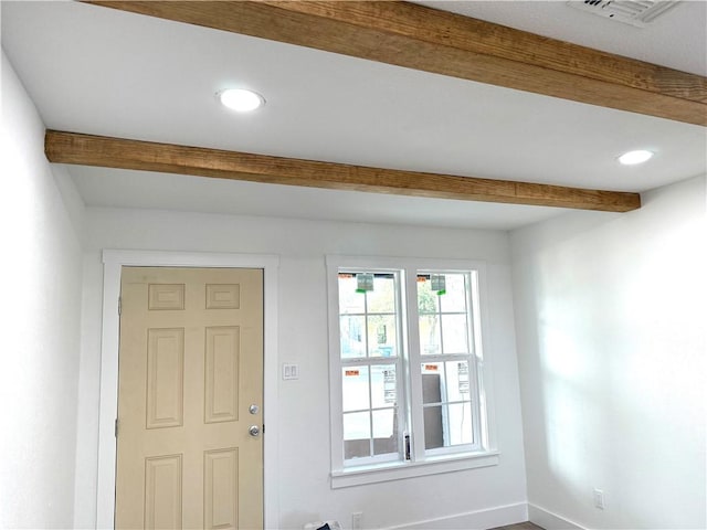 interior space featuring beam ceiling