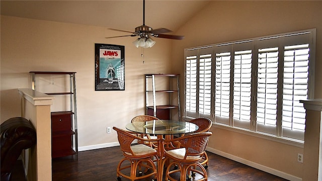 dining room with a healthy amount of sunlight, dark hardwood / wood-style floors, ceiling fan, and vaulted ceiling