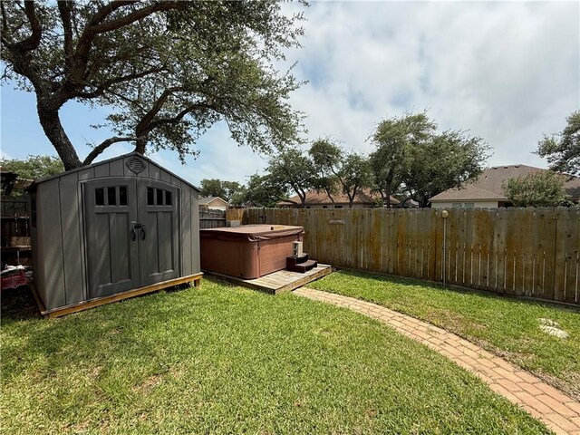177 Whistlers Cv, Rockport, TX 78382 - view of yard with a hot tub, a storage shed, and an outbuilding