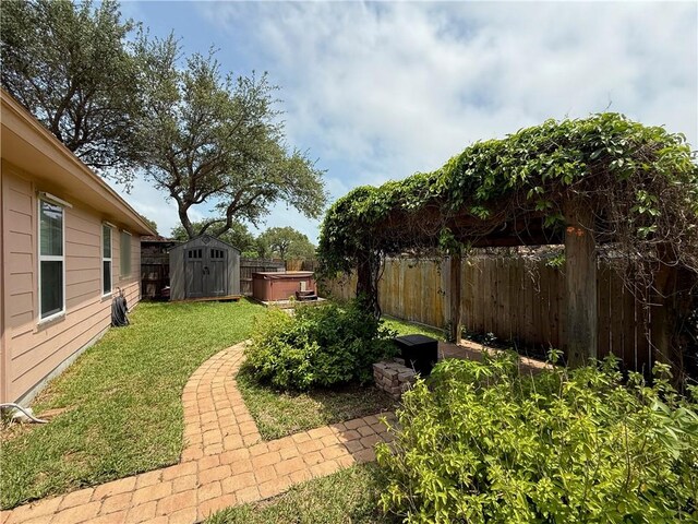177 Whistlers Cv, Rockport, TX 78382 - view of yard with a hot tub, a storage shed, and an outdoor structure