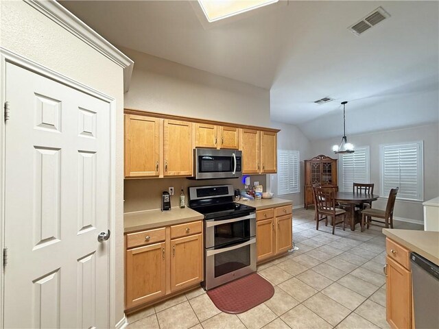 177 Whistlers Cv, Rockport, TX 78382 - kitchen featuring appliances with stainless steel finishes, vaulted ceiling, a chandelier, light countertops, and light tile patterned floors
