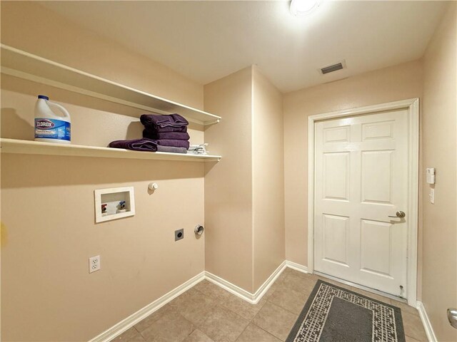 177 Whistlers Cv, Rockport, TX 78382 - laundry room featuring electric dryer hookup, hookup for a washing machine, baseboards, hookup for a gas dryer, and light tile patterned flooring