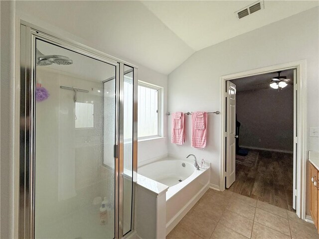 177 Whistlers Cv, Rockport, TX 78382 - bathroom with a shower stall, vaulted ceiling, a bath, tile patterned flooring, and vanity