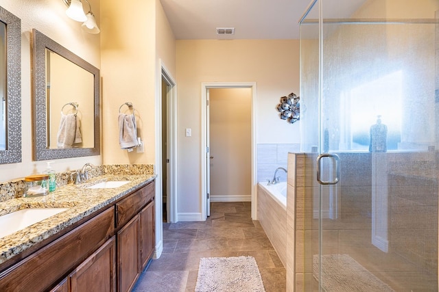 bathroom featuring vanity and shower with separate bathtub