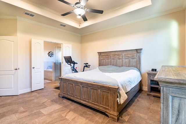 bedroom featuring connected bathroom, a tray ceiling, ceiling fan, and crown molding