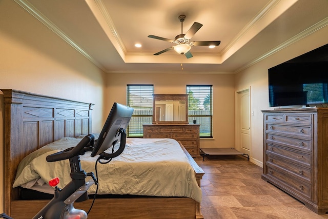 bedroom featuring ceiling fan, ornamental molding, and a raised ceiling