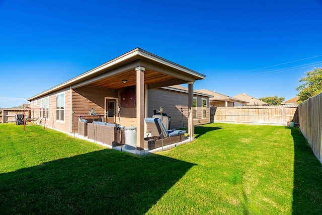 rear view of house with a lawn and a patio