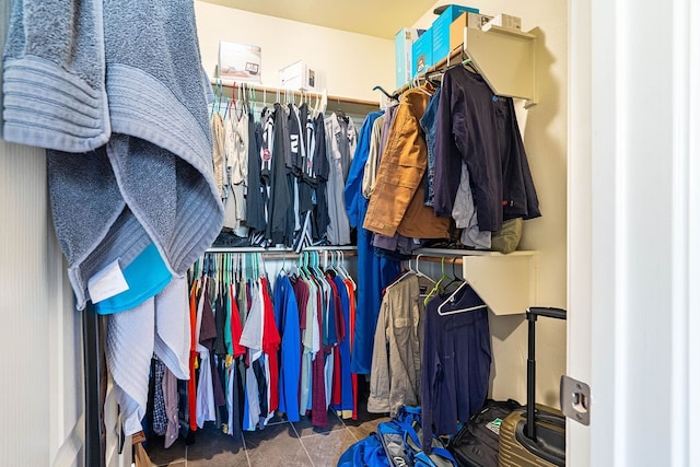 spacious closet featuring dark tile patterned floors