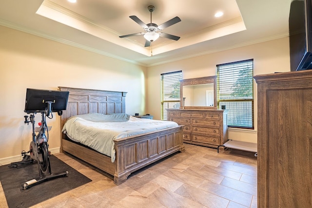 bedroom featuring ceiling fan, crown molding, and a tray ceiling