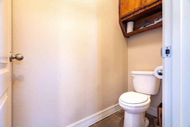 bathroom with tile patterned flooring and toilet