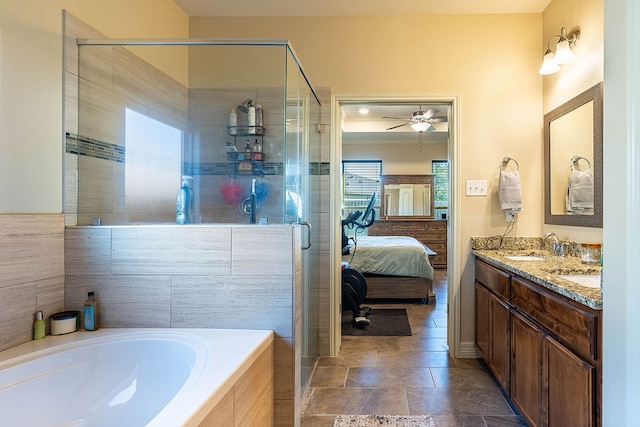 bathroom with vanity and shower with separate bathtub