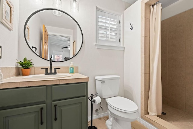 bathroom featuring toilet, walk in shower, vanity, and ceiling fan