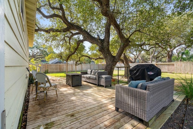 deck featuring an outdoor living space with a fire pit and a grill