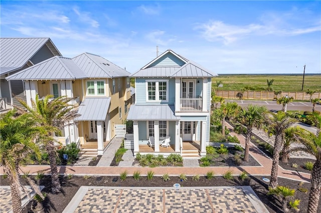 320 S Shore Dr, Port Aransas, TX 78373 - view of front of property featuring a metal roof, a porch, a balcony, and a standing seam roof