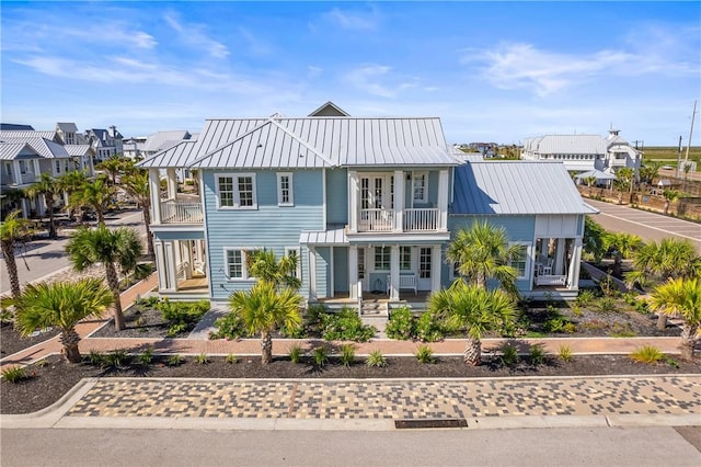 320 S Shore Dr, Port Aransas, TX 78373 - view of front of house featuring a balcony, covered porch, a standing seam roof, and a metal roof