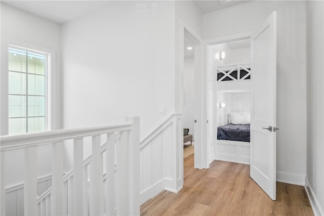 320 S Shore Dr, Port Aransas, TX 78373 - hall with light wood finished floors, a decorative wall, and a wainscoted wall
