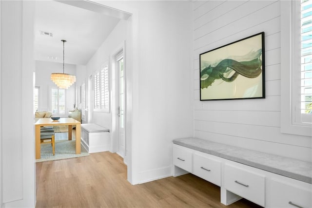 320 S Shore Dr, Port Aransas, TX 78373 - hallway featuring light wood-style flooring, healthy amount of natural light, and a chandelier