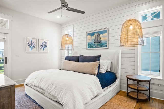 328 Coastline Dr, Port Aransas, TX 78373 - bedroom featuring wood finished floors, recessed lighting, wood walls, and ceiling fan