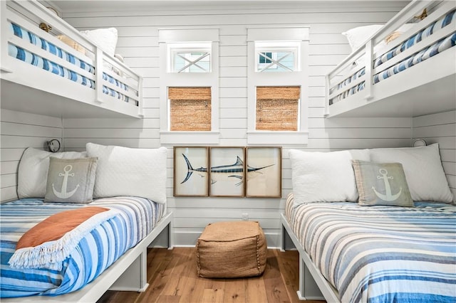 328 Coastline Dr, Port Aransas, TX 78373 - bedroom featuring wood finished floors and wood walls