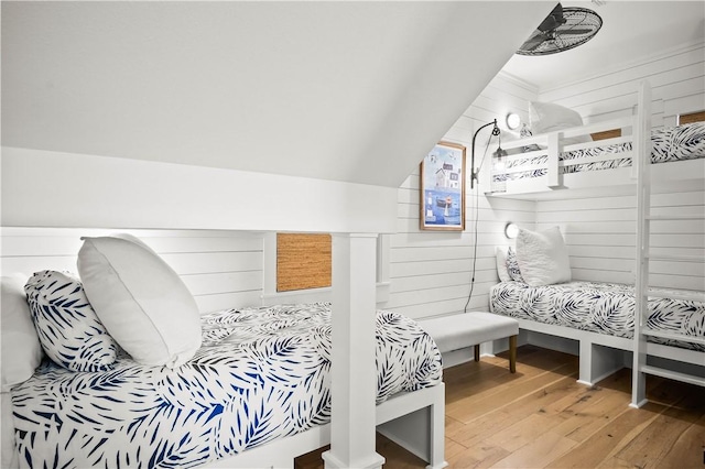 328 Coastline Dr, Port Aransas, TX 78373 - bedroom with light wood-type flooring and wooden walls