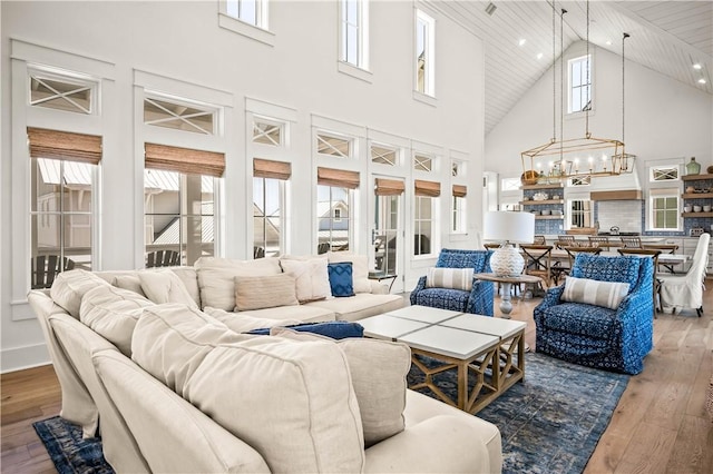 328 Coastline Dr, Port Aransas, TX 78373 - living area featuring a chandelier, high vaulted ceiling, and hardwood / wood-style flooring