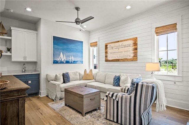 328 Coastline Dr, Port Aransas, TX 78373 - living area with light wood-style flooring, wood walls, a ceiling fan, and recessed lighting