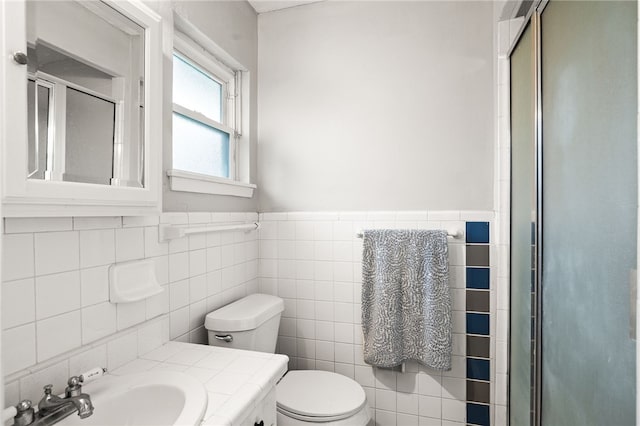 4249 Dody St, Corpus Christi, TX 78411 - full bath with a stall shower, tile walls, vanity, and a wainscoted wall