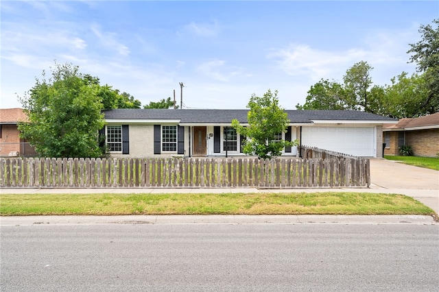4249 Dody St, Corpus Christi, TX 78411 - ranch-style house featuring an attached garage, driveway, and a fenced front yard