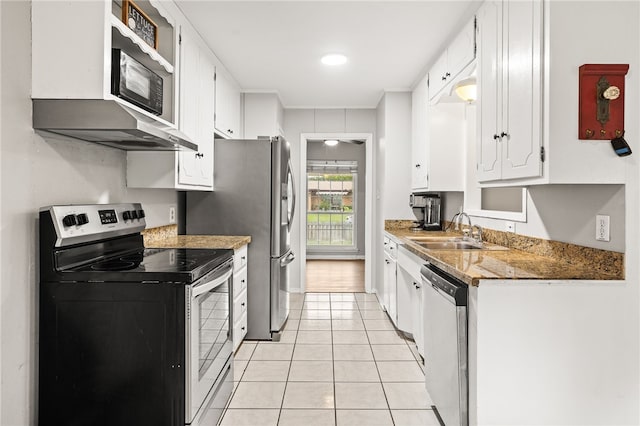 4249 Dody St, Corpus Christi, TX 78411 - kitchen with stainless steel appliances, white cabinets, ventilation hood, and light tile patterned floors
