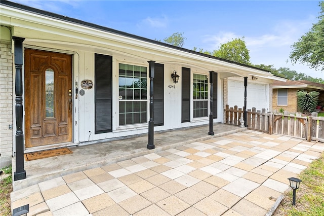 4249 Dody St, Corpus Christi, TX 78411 - property entrance with an attached garage and a porch