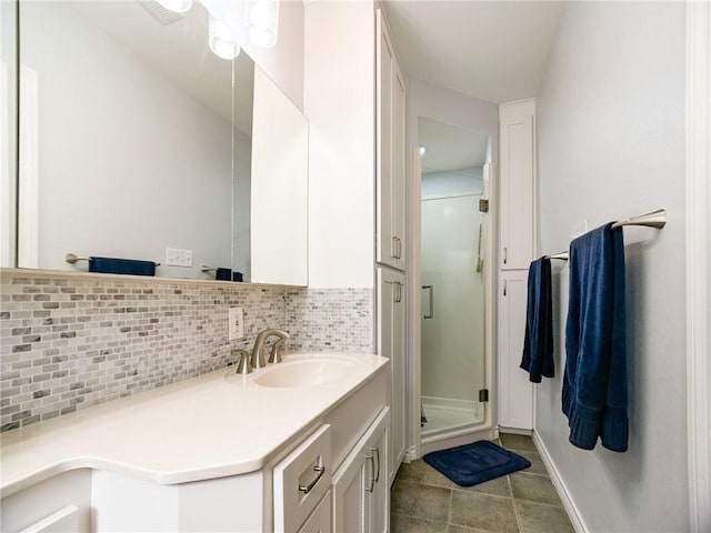 full bath with visible vents, tile patterned floors, vanity, a shower stall, and backsplash