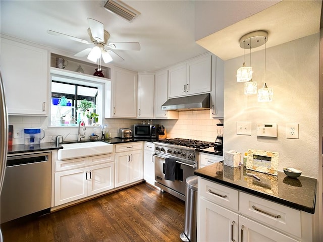 kitchen with pendant lighting, high end stainless steel range, white cabinets, dishwasher, and under cabinet range hood