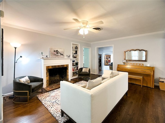 living room featuring ceiling fan, visible vents, dark wood finished floors, and crown molding