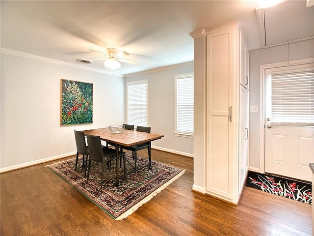 dining room with attic access, baseboards, dark wood finished floors, and crown molding