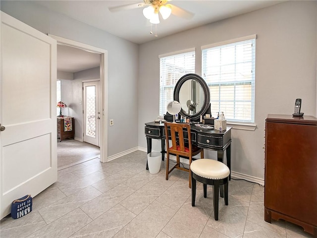 office area featuring ceiling fan, baseboards, and light tile patterned floors