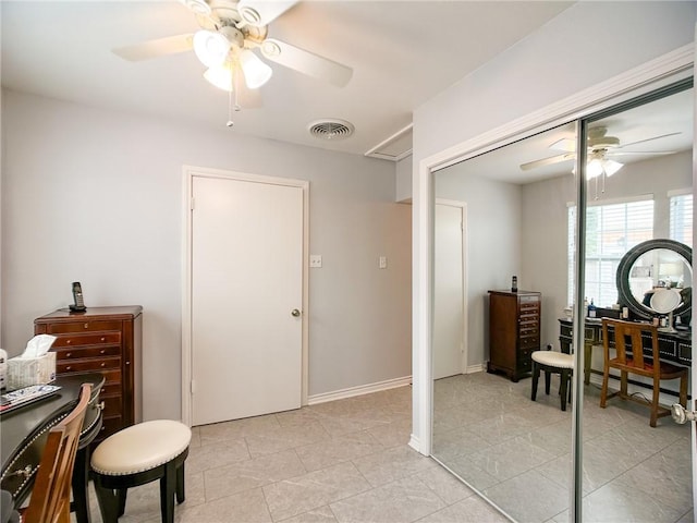 office with ceiling fan, light tile patterned floors, visible vents, and baseboards