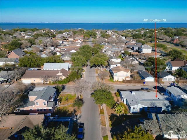 drone / aerial view featuring a residential view and a water view