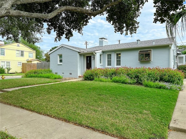 ranch-style house featuring crawl space, a front yard, a chimney, and brick siding