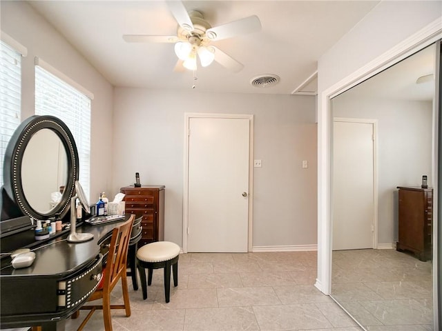 home office with ceiling fan, light tile patterned floors, visible vents, and baseboards