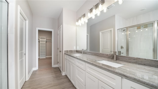 bathroom featuring vanity, hardwood / wood-style flooring, and an enclosed shower