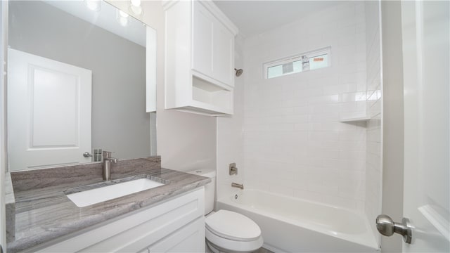 full bathroom with vanity, tiled shower / bath combo, and toilet