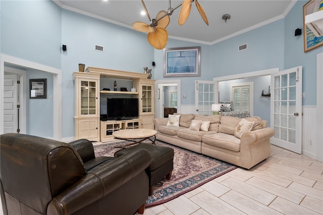 living room with ornamental molding, high vaulted ceiling, ceiling fan, and french doors