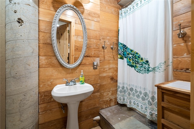 bathroom featuring wood walls