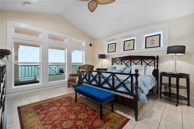 tiled bedroom featuring a water view, ceiling fan, and vaulted ceiling