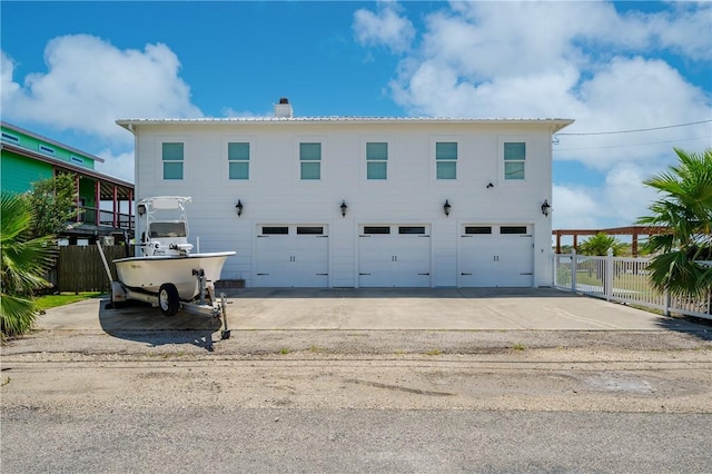 204 Bayshore Dr, Ingleside, TX 78362 - back of house with a garage, a chimney, and driveway