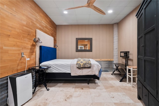 bedroom with wood walls and ceiling fan