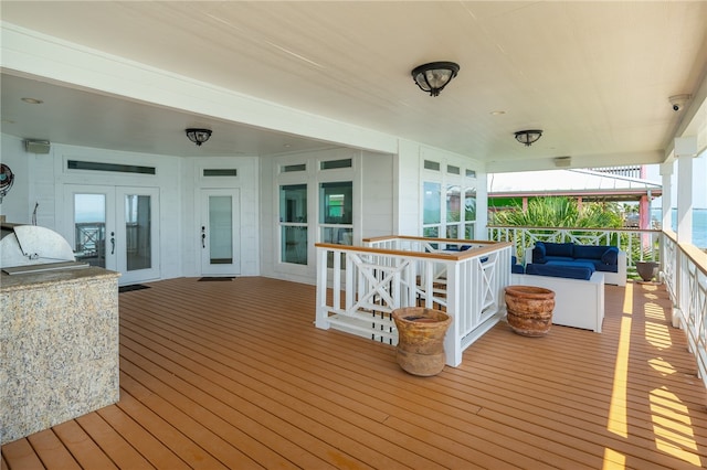 wooden deck featuring a water view and french doors