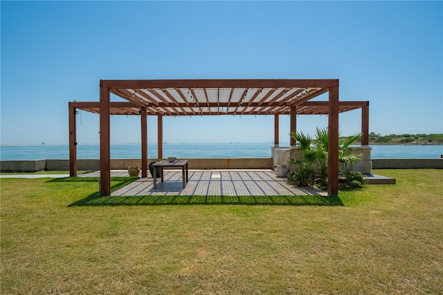 exterior space featuring a water view, a yard, and a pergola