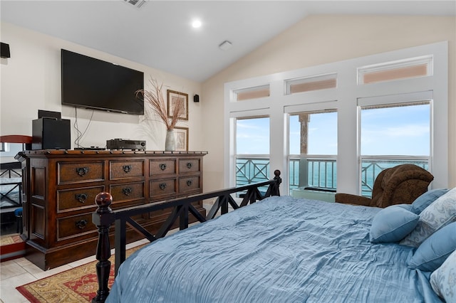 tiled bedroom with lofted ceiling and multiple windows