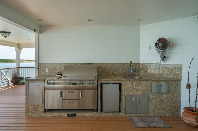 kitchen with backsplash, a water view, sink, and light hardwood / wood-style floors